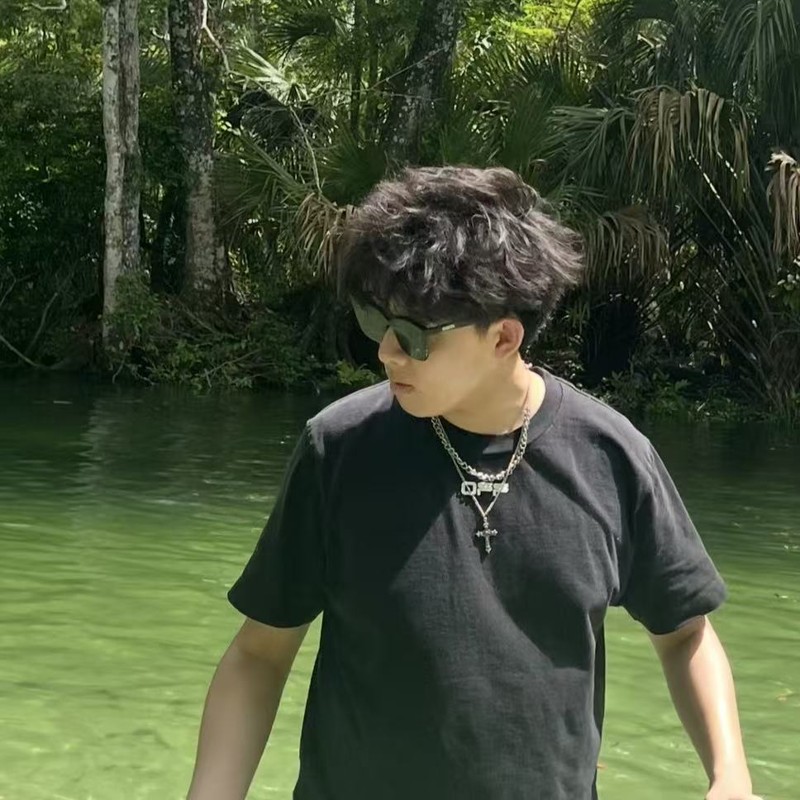 Eric wearing sunglasses beside the water